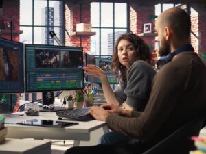Man and woman filmmakers editing video shoot in post production